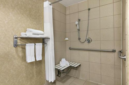 a shower in a hotel bathroom with towels at Hampton Inn & Suites Lawton in Lawton