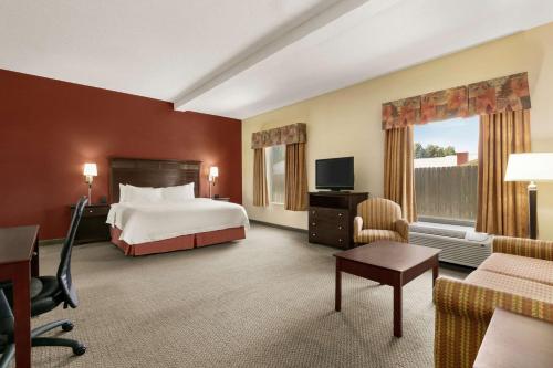 a hotel room with a bed and a desk at Hampton Inn & Suites Lawton in Lawton