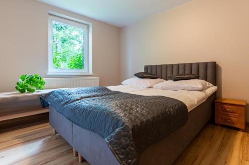 a bedroom with a large bed and a window at Willa Malinówka - ogród wypoczynkowy z widokiem na Śnieżkę in Karpacz