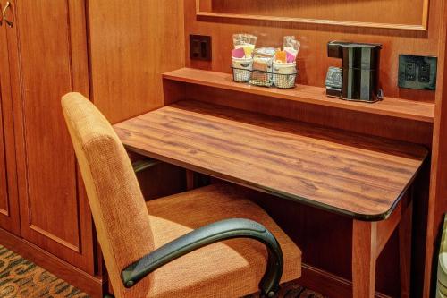 a wooden table and a chair in a room at Hampton Inn Winchester KY in Winchester