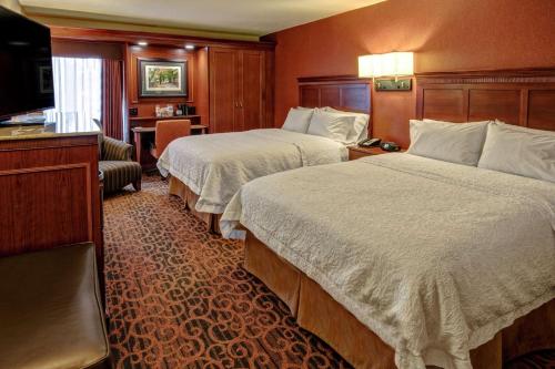 a hotel room with two beds and a television at Hampton Inn Winchester KY in Winchester