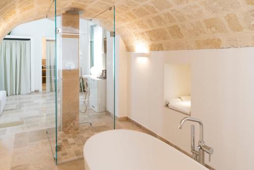 a bathroom with a toilet and a glass shower at Masseria San Nicola Savelletri - B&B in Fasano