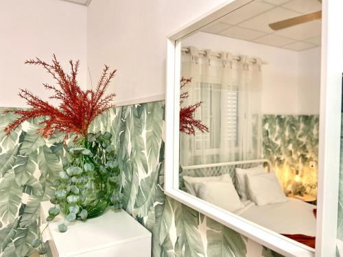 un espejo y una planta en una habitación en CASA SOLE - Apartamento Playa San Juan, en Guía de Isora