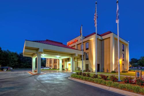 a hotel front of a building with a parking lot at Hampton Inn Laurinburg in Laurinburg