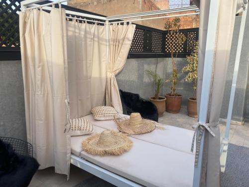 a white bed with two pillows and a curtain at YVES Marrakech in Marrakech