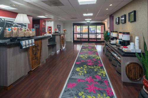 a restaurant with a long corridor with a floral carpet at Hampton Inn Livermore in Livermore
