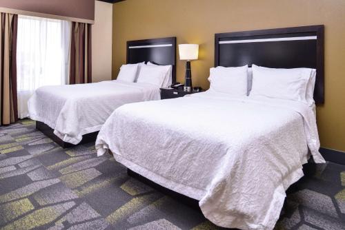 two beds in a hotel room with white sheets at Hampton Inn & Suites Big Spring in Big Spring