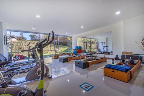 a gym with a treadmill and a fitness room at PORTANOVA Suites by ADVENTU in Rionegro