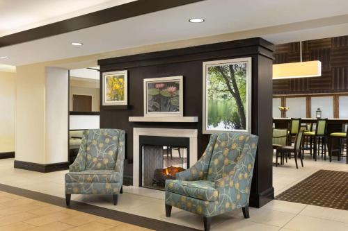 a lobby with two chairs and a fireplace at Hampton Inn & Suites Mahwah in Mahwah