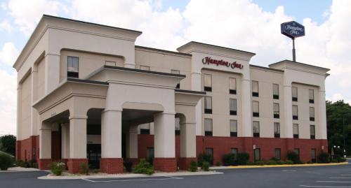 a white building with a sign on top of it at Hampton Inn Inwood in Inwood