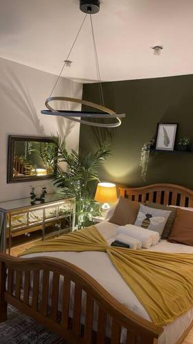 a bedroom with a bed and a potted plant at Stylish home close to Arena in Wincobank