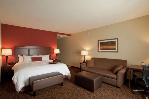 Großes Hotelzimmer mit einem Bett und einem Sofa in der Unterkunft Hampton Inn & Suites McAllen in McAllen
