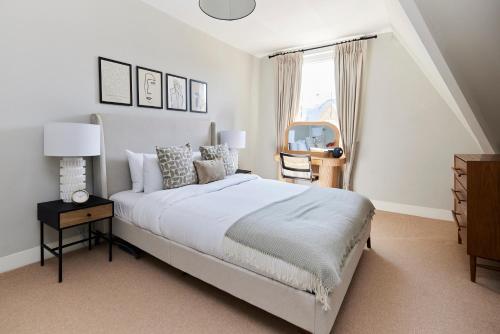 a bedroom with a large bed and a window at The Lambeth Arms - Prestigious 3BDR Flat in London