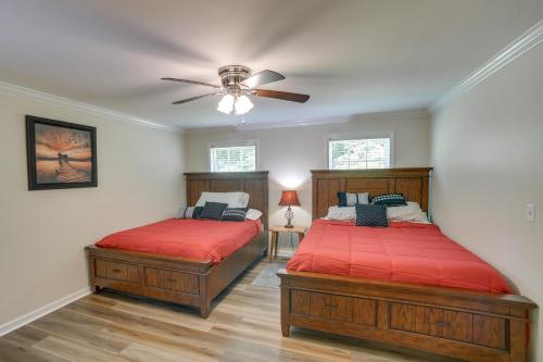 a bedroom with two beds and a ceiling fan at Guntersville Lake House Dock and Boat Ramp Access! in Scottsboro