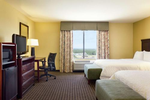 a hotel room with two beds and a television at Hampton Inn & Suites Prattville in Prattville