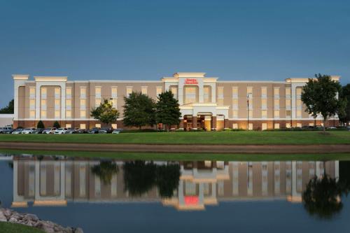 a large building with a reflection in a body of water at Hampton Inn & Suites Montgomery-EastChase in Montgomery
