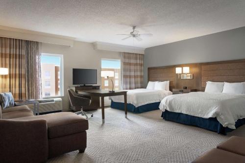 a hotel room with two beds and a desk at Hampton Inn & Suites Montgomery-EastChase in Montgomery