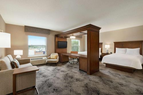 a hotel room with a bed and a desk at Hampton Inn & Suites Exeter in Exeter