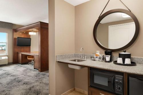 a bathroom with a sink and a mirror at Hampton Inn & Suites Exeter in Exeter