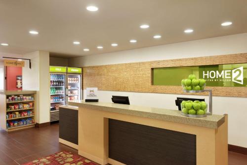a store lobby with a counter with apples on it at Home2 Suites by Hilton Florida City in Florida City