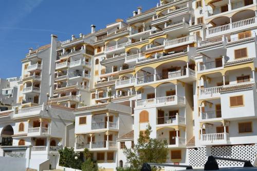 a large white apartment building with white balconies at Apartamentos Bon Amb in Faro de Cullera