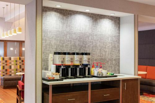 a counter with wine bottles on it in a restaurant at Hampton Inn & Suites Marshalltown in Marshalltown