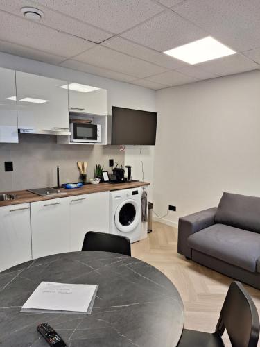 a kitchen and living room with a table and a couch at Perfect studio 14 H center Rotterdam in Rotterdam