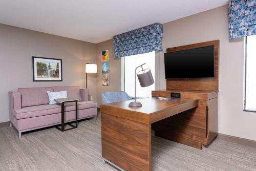 a hotel room with a desk and a television at Hampton Inn & Suites Marshalltown in Marshalltown