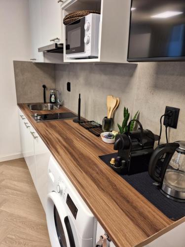a kitchen with a wooden counter top with a microwave at Perfect studio 14 H center Rotterdam in Rotterdam
