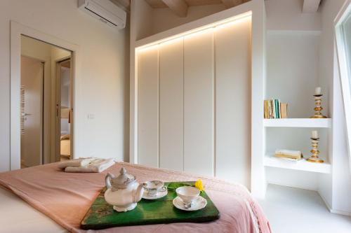 1 dormitorio con 1 cama con 2 sets de té en una bandeja en Mia House - Alloggio da sogno a Civitanova Alta, en Civitanova Alta