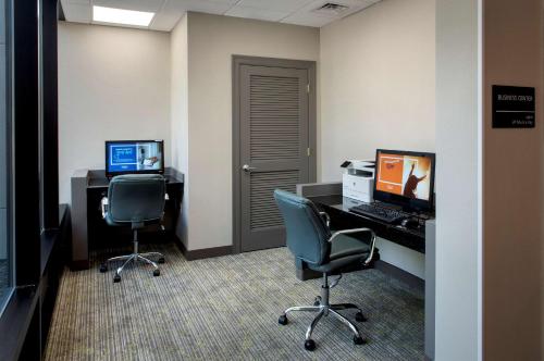 an office with two chairs and a desk with a computer at Hampton Inn Middletown in Middletown