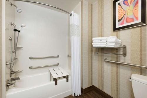 a bathroom with a shower and a tub and a toilet at Hampton Inn West Monroe in West Monroe
