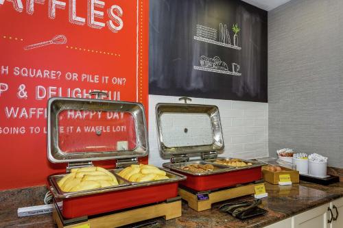 a food stand with buns in trays on a counter at Hampton Inn & Suites Mobile - Downtown Historic District in Mobile