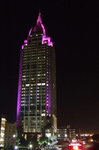 a large building with purple lights on it at night at Homewood Suites by Hilton Mobile Airport-University Area in Mobile