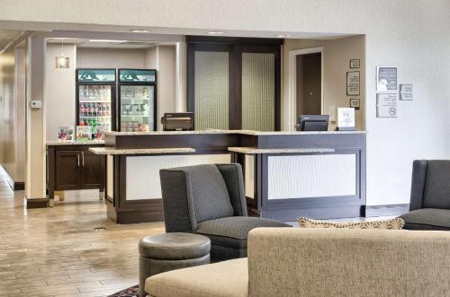 a waiting room with chairs and a counter in a store at Homewood Suites by Hilton Mobile Airport-University Area in Mobile