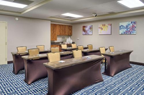 a conference room with tables and chairs in it at Homewood Suites by Hilton Mobile Airport-University Area in Mobile