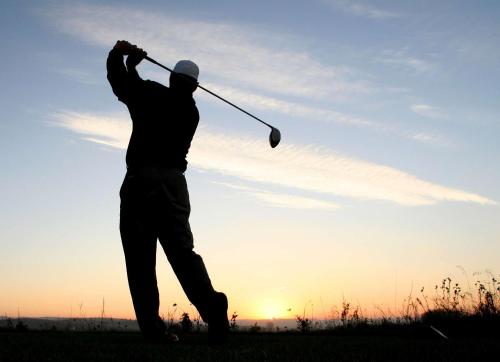 a man hitting a golf ball with a club at Homewood Suites by Hilton Mobile Airport-University Area in Mobile