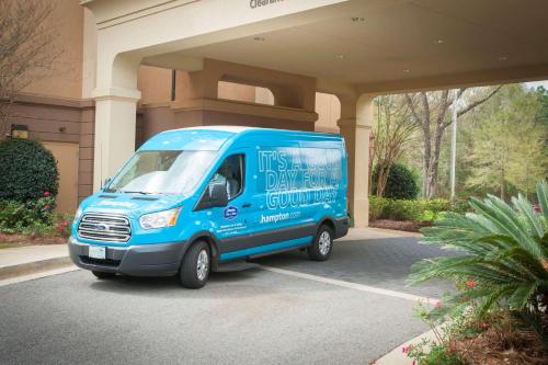 a blue van parked in front of a building at Hampton Inn & Suites Mobile Providence Park/Airport in Mobile