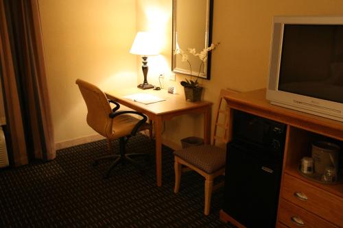 a room with a desk with a lamp and a chair at Hampton Inn & Suites Mobile Providence Park/Airport in Mobile
