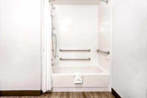 a bathroom with a bath tub and a sink at Hampton Inn Morganton in Morganton