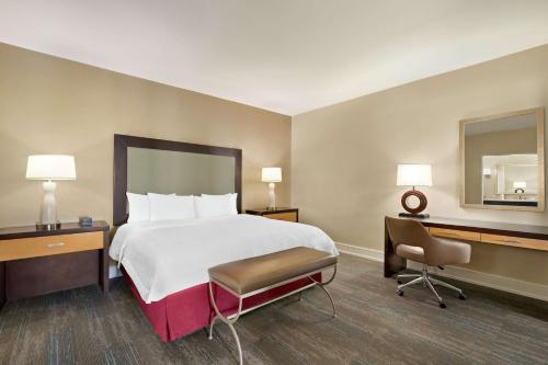 a hotel room with a bed and a desk and a chair at Hampton Inn Downtown / French Quarter Area in New Orleans