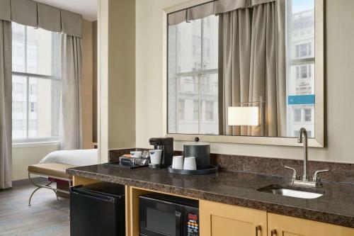 a hotel room with a sink and a mirror at Hampton Inn Downtown / French Quarter Area in New Orleans