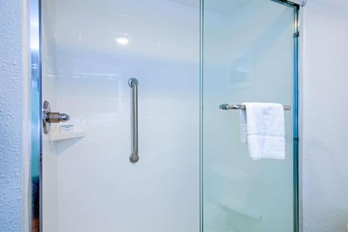 a shower with a glass door and a towel at Hampton Inn Slidell in Slidell