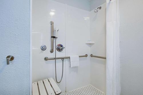 a bathroom with a shower with a bench in it at Hampton Inn Slidell in Slidell