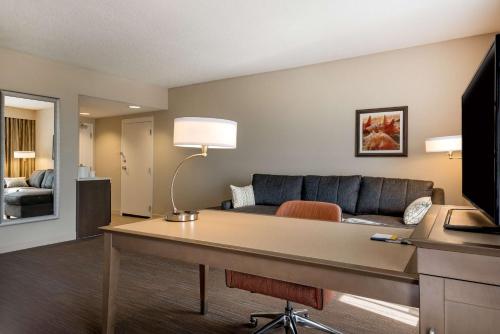 a living room with a couch and a table in a room at Hampton Inn Myrtle Beach West in Myrtle Beach
