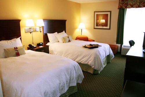 a hotel room with two beds and a window at Hampton Inn New Bern in New Bern