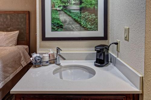 a bathroom sink with a coffee maker on top of it at Hampton Inn Newberry Opera House in Newberry