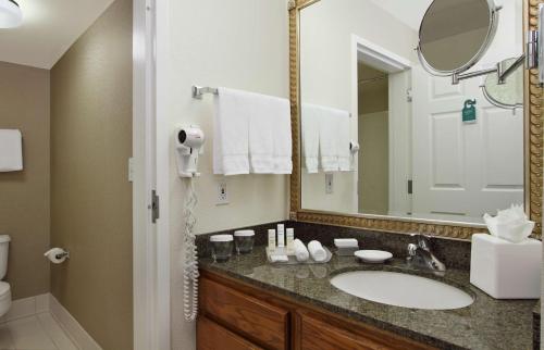 a bathroom with a sink and a mirror at Homewood Suites by Hilton Newark Fremont in Fremont