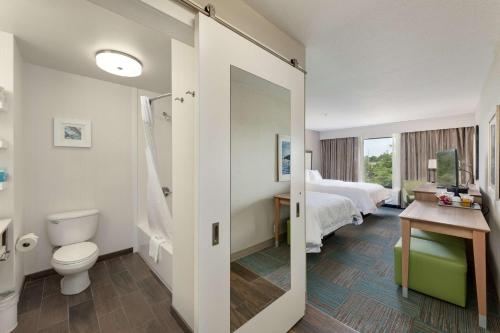 a hotel room with a bathroom with a bed and a toilet at Hampton Inn Niceville-Elgin Air Force Base in Niceville