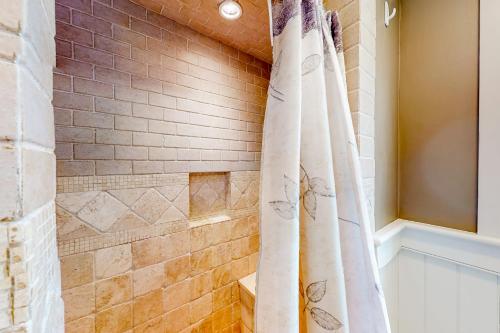 a bathroom with a walk in shower with a shower curtain at Overland Glen in Mashpee